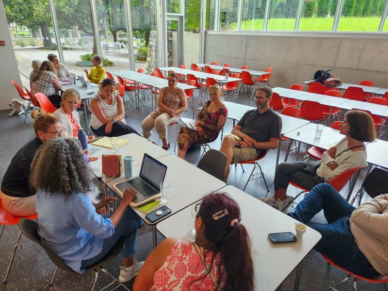 A large group of people sitting around tables at the Steger Center