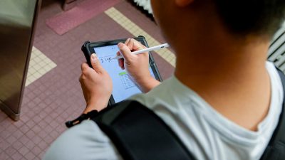 Student writing down data at Patton Hall as part of a sustainability project