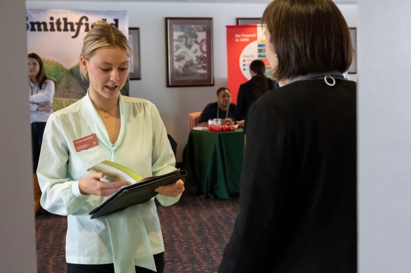Virginia Tech student networking with an employer at the 2022 Agricultural and Applied Economics Career Fair. Photo by Clark DeHart for Virginia Tech. 